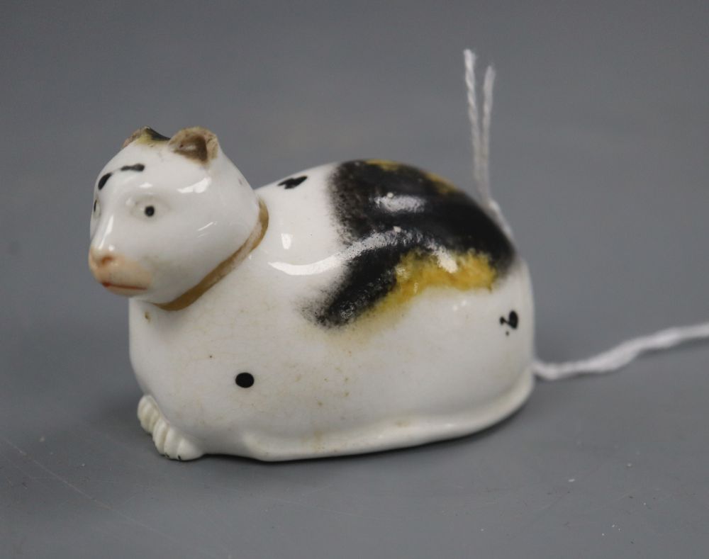 A Derby porcelain figure of a recumbent cat, c.1830, incised 1 to the base